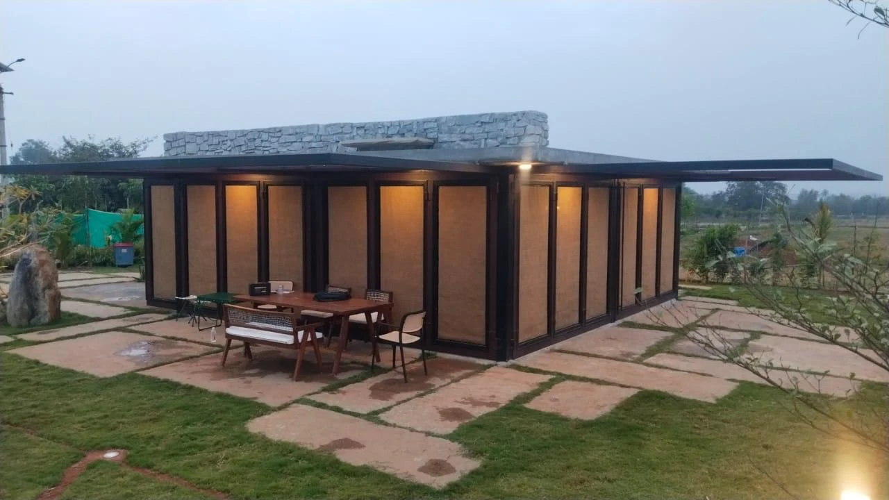 Contemporary pavilion with full-height glazing, timber screens and landscaped stone paths