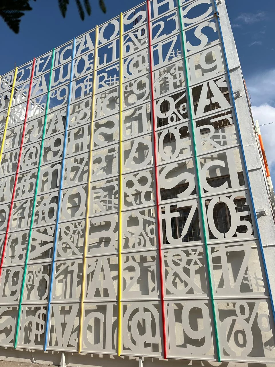 Tall decorative facade with patterned letter panels