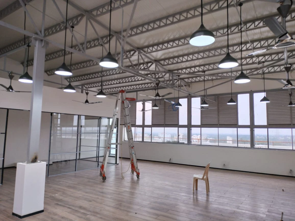 Commercial workspace with exposed ceiling services and glass partitions